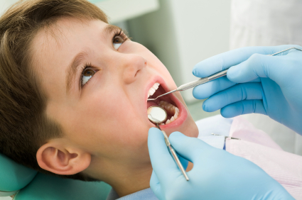 Child being examined in dental chair